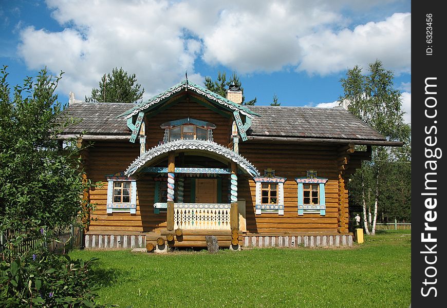 Russian style. Wooden blockhouse on the blue sky background. Russian style. Wooden blockhouse on the blue sky background.