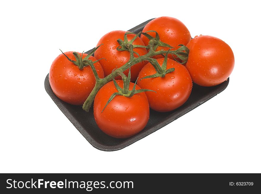 Tomatoes packed in a plastic container on white