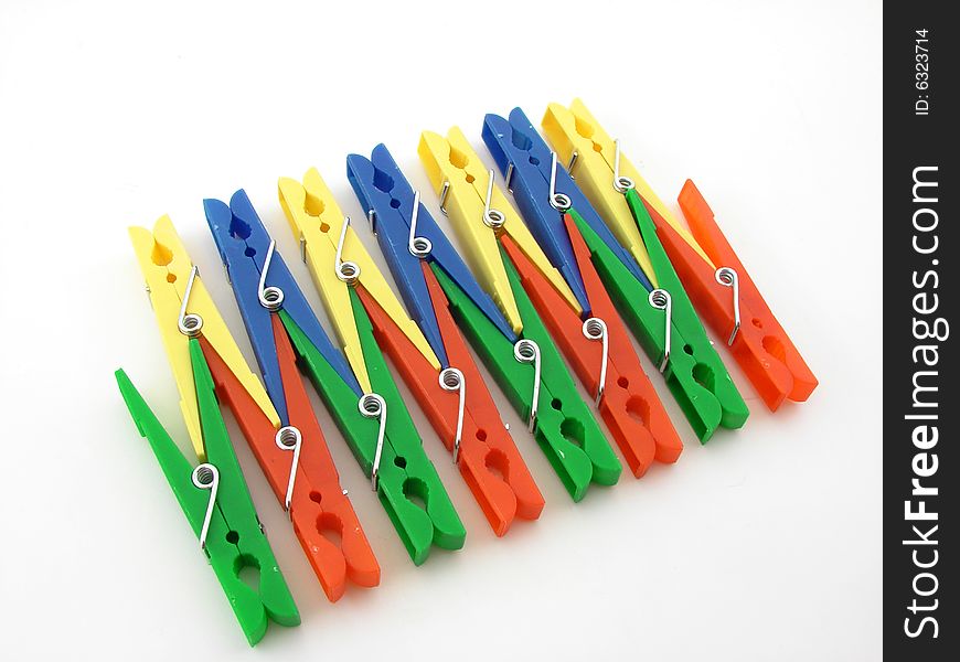 Green, red, blue and yellow clothes-pegs isolated over white background.