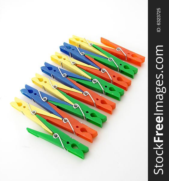 Green, red, blue and yellow clothes-pegs isolated over white background.