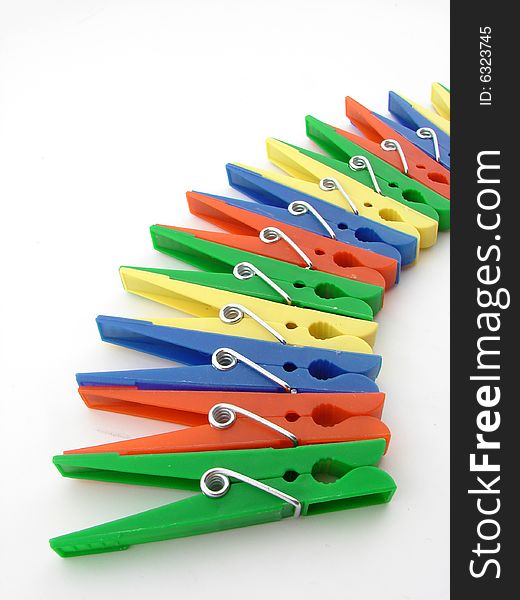 Green, red, blue and yellow clothes-pegs isolated over white background.