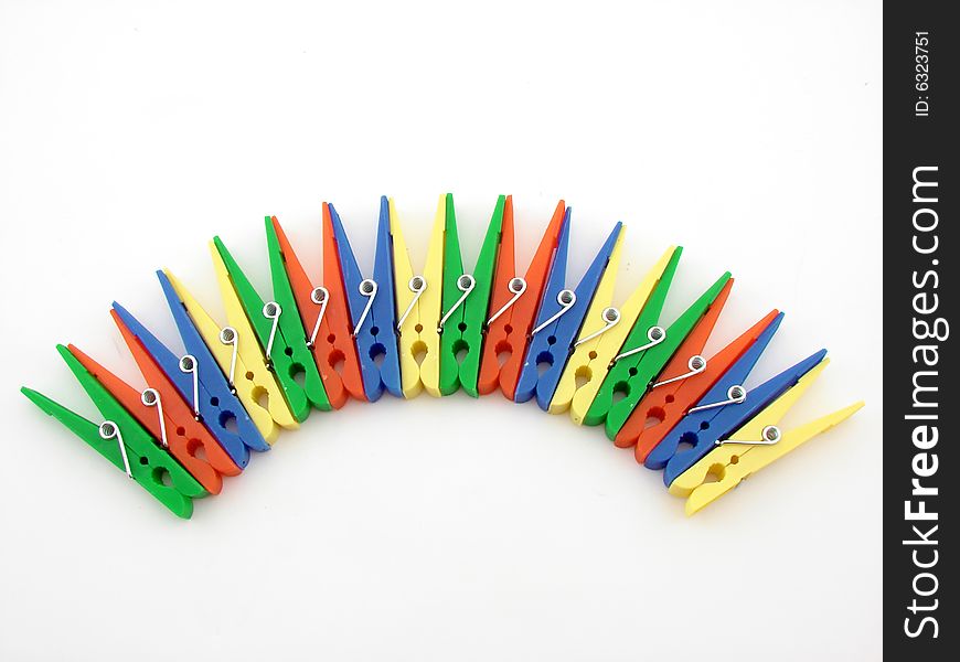 Green, red, blue and yellow clothes-pegs isolated over white background.