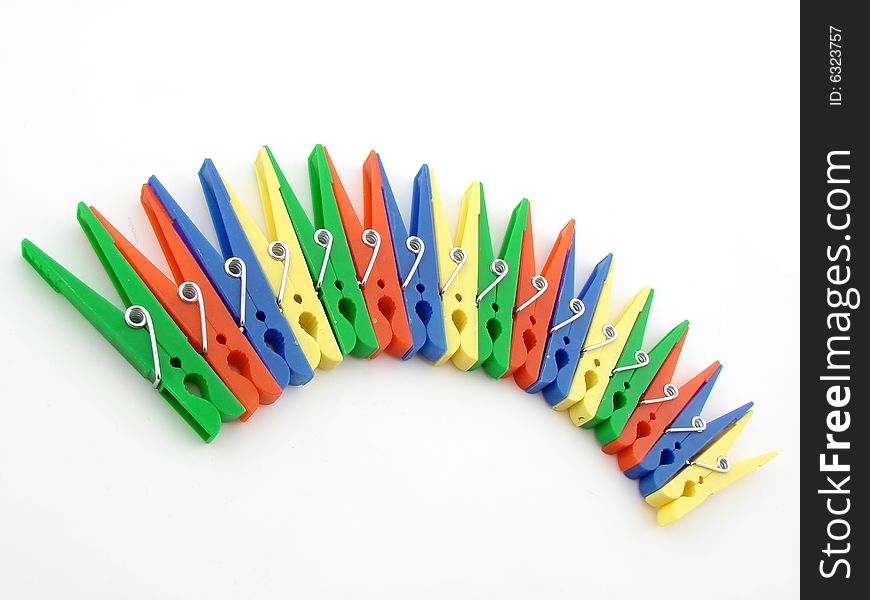 Green, red, blue and yellow clothes-pegs isolated over white background.