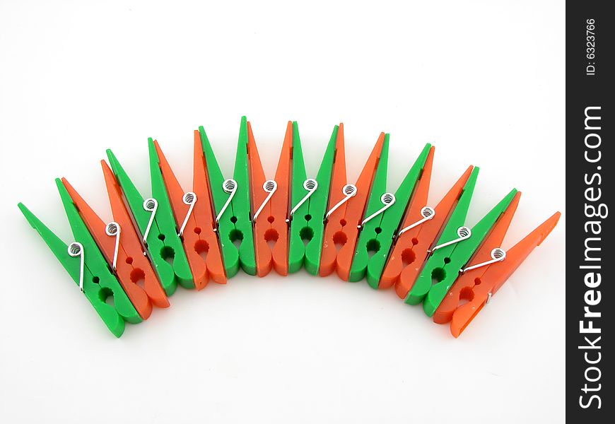 Green and red clothes-pegs isolated over white background.