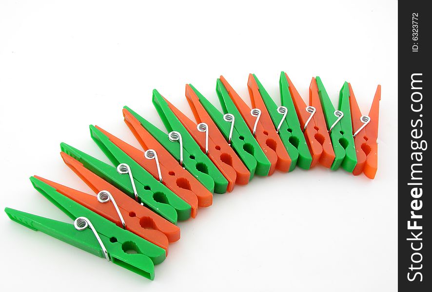 Green and red clothes-pegs isolated over white background.