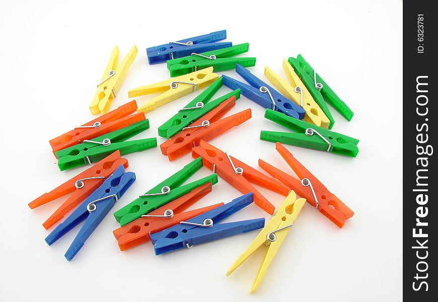 Green, red, blue and yellow clothes-pegs isolated over white background.