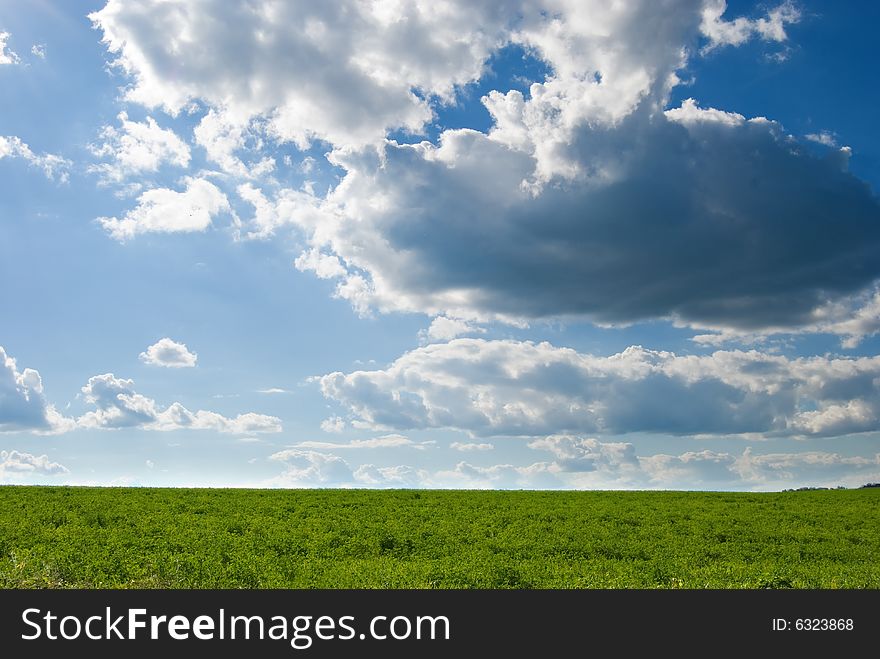 Dramatic clouds over a green pasture. Dramatic clouds over a green pasture