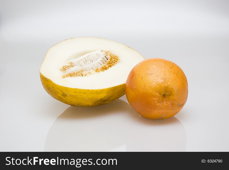 Half of yellow melon and orange grapefruit. Half of yellow melon and orange grapefruit
