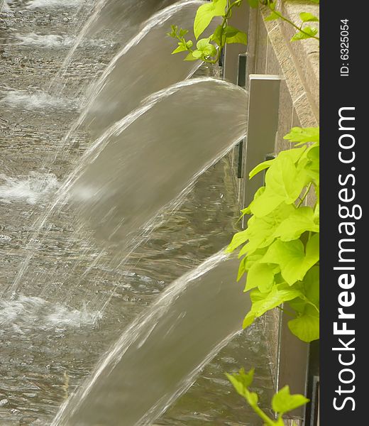 Streams of water flow from city fountain. Streams of water flow from city fountain