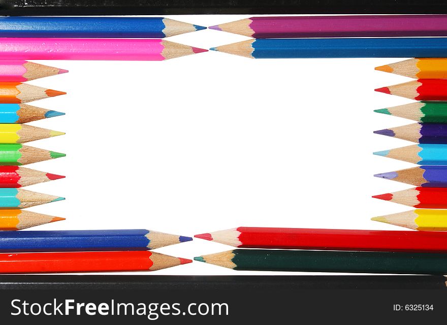 Colored pencils form a rectangular frame white space in center. Colored pencils form a rectangular frame white space in center