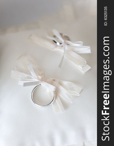 Wedding rings on a white pillow