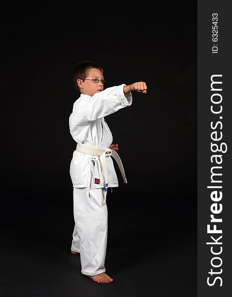 Traditional karate student demonstrating right stance with a punch to the nose. Traditional karate student demonstrating right stance with a punch to the nose