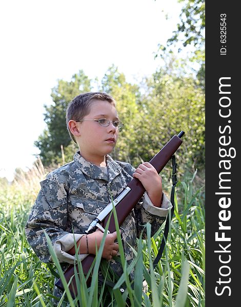 Young Boy Holding Toy Rifle