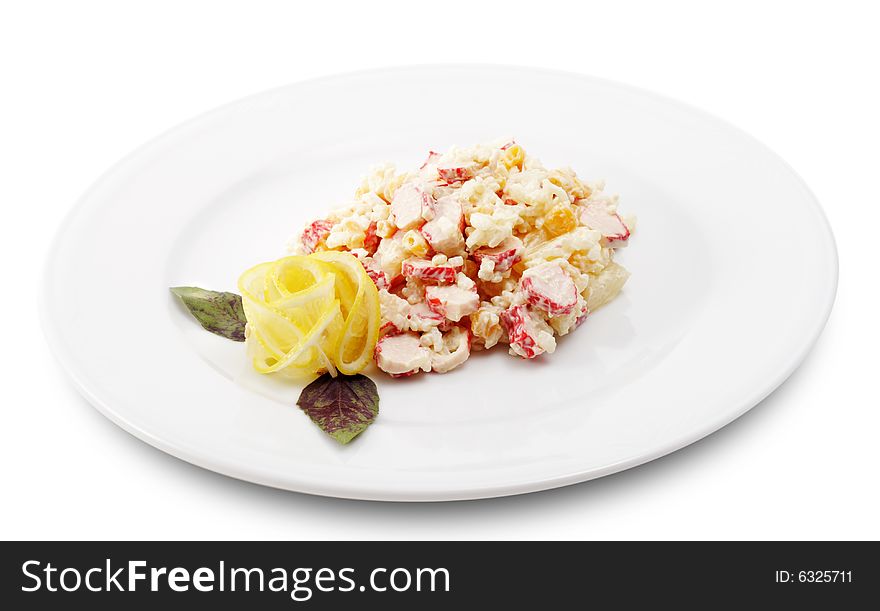 Salad Comprises Crab Meat, Rice, Pineapple and Corn Dressed with Lemon Slice (Abstract Flower) and Leaf of Basil. Isolated on White Background. Salad Comprises Crab Meat, Rice, Pineapple and Corn Dressed with Lemon Slice (Abstract Flower) and Leaf of Basil. Isolated on White Background