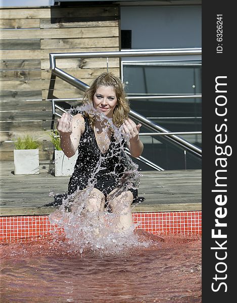 Woman splashing water on pool