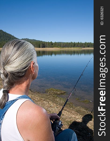 Senior woman fishing at lake