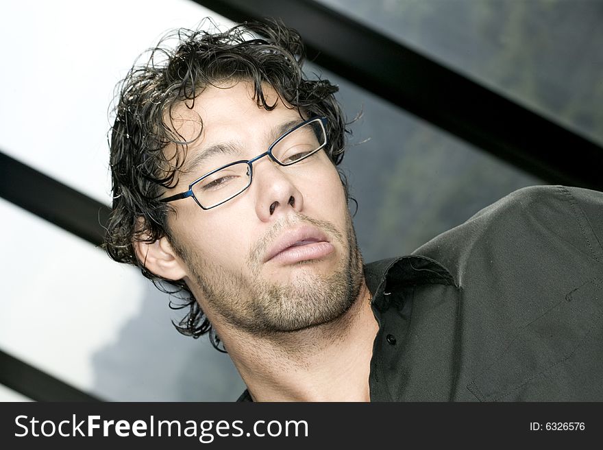 Young man with glasses making a funny face. Young man with glasses making a funny face