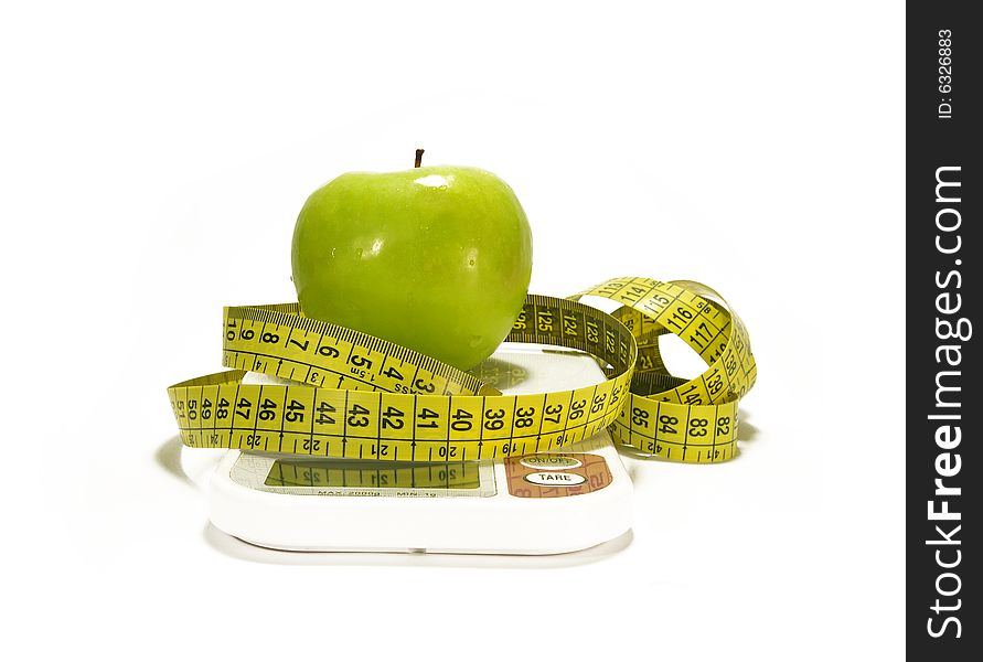 Green Apple And Tape Measure On White