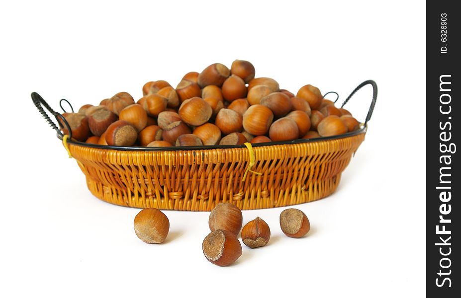 Wood nuts in a basket isolated on a white background. Wood nuts in a basket isolated on a white background