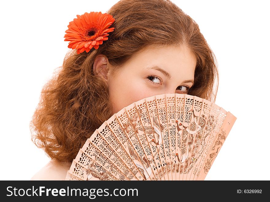 Young beautiful woman face behind Chinese fan. Young beautiful woman face behind Chinese fan