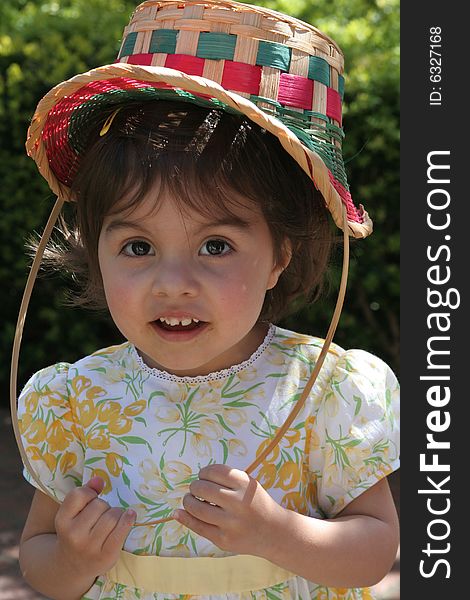 Young Girl wearing an Easter Basket as a bonnet. Young Girl wearing an Easter Basket as a bonnet