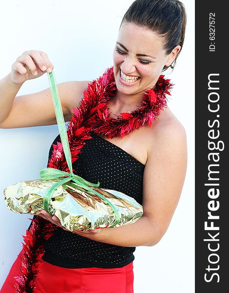 Isolated Christmas portrait of a happy woman with a gift.