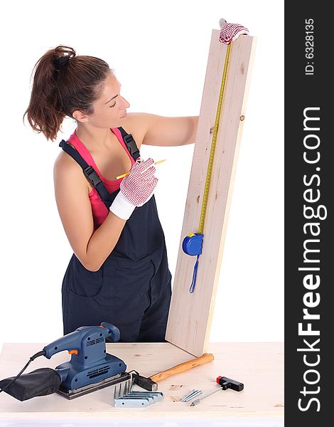 Woman carpenter with wooden plank and measuring tape