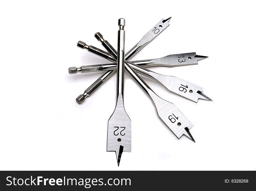 Drill bits on a white linen background, numbered in size.