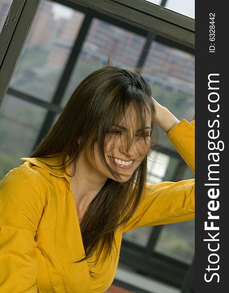 Young happy woman playing with her hair