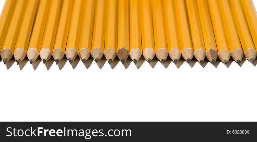Identical and Sharp Yellow No. 2 Pencils Aligned in a Row from Top of Page Isolated on a White Background. Identical and Sharp Yellow No. 2 Pencils Aligned in a Row from Top of Page Isolated on a White Background