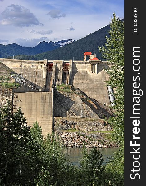 Concrete hydro electric dam station in mountain setting