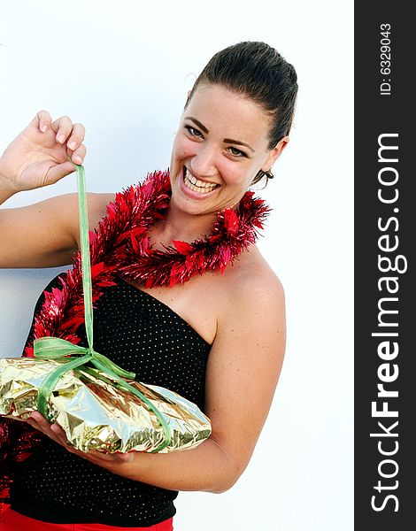 Pretty brunette woman opening a Christmas present. Pretty brunette woman opening a Christmas present.