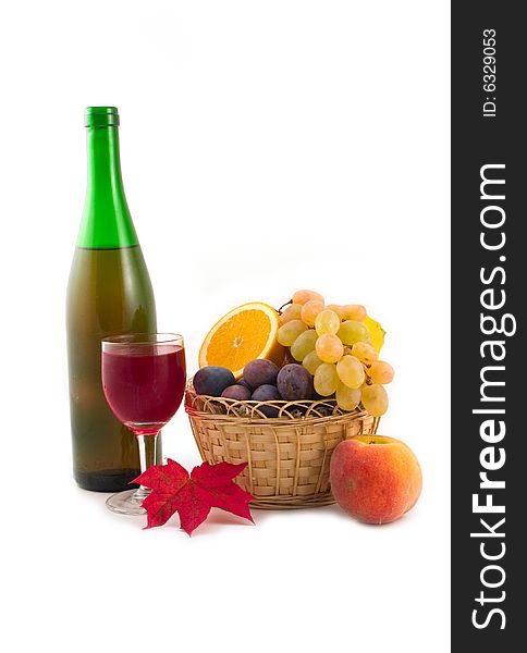 Bottle fault in a yellow basket and plums on a white background