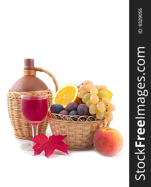 Bottle fault in a yellow basket and grapes on a white background