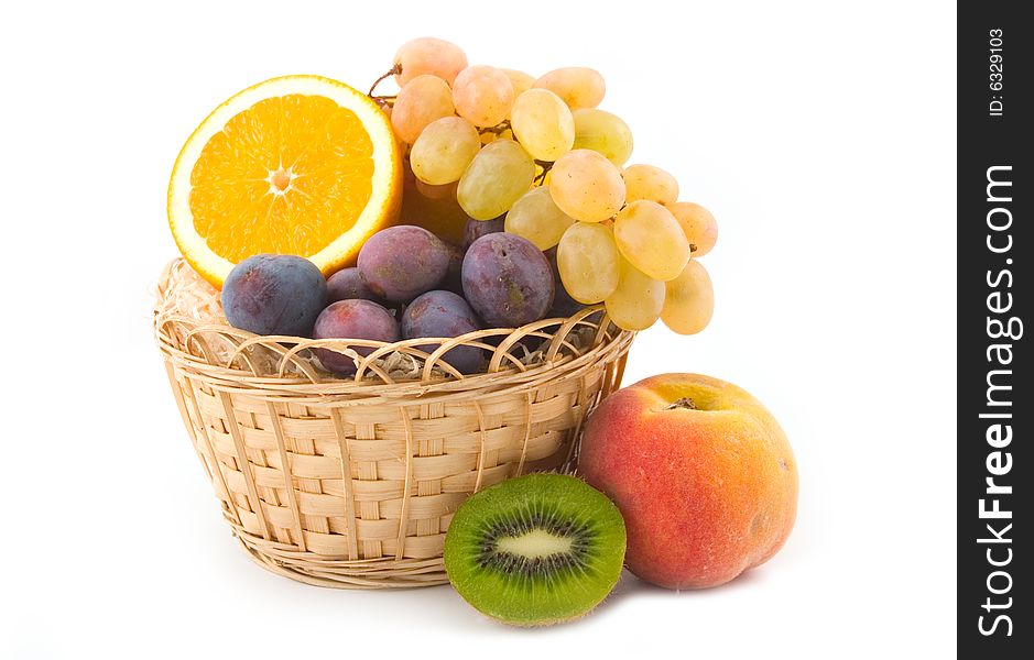 Ripe fruit in a yellow basket on a white background. Ripe fruit in a yellow basket on a white background