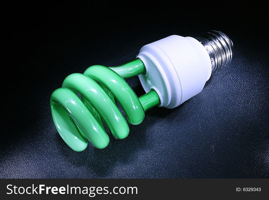 Background with green energy-efficient electric bulb. Background with green energy-efficient electric bulb