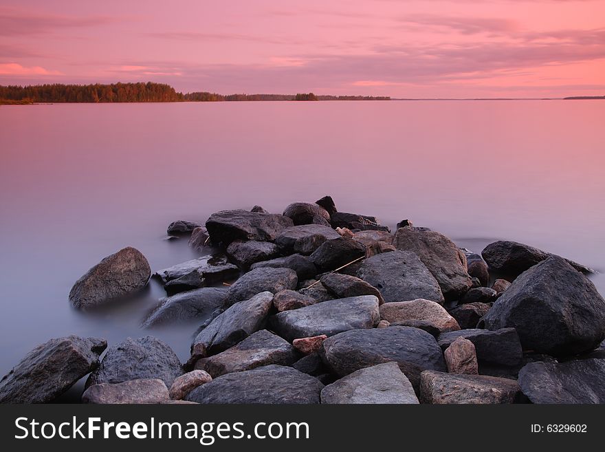 Sunset by the lake, rocks, long exposure