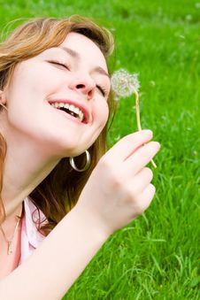 Girl Blowing On The Dandelion Royalty Free Stock Photo