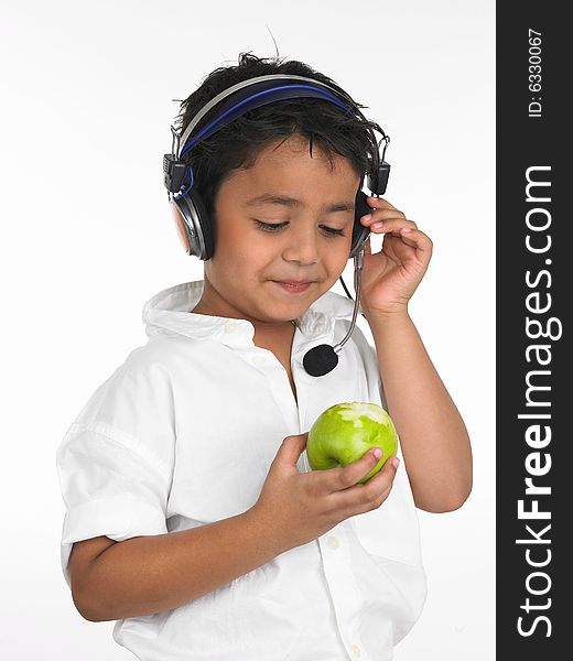 Asian boy biting into a green apple