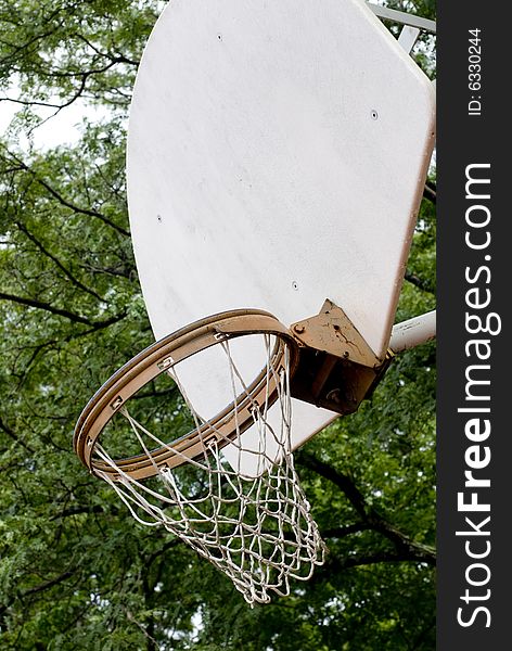 Worn basketball net and rim attached to a white backboard. Worn basketball net and rim attached to a white backboard