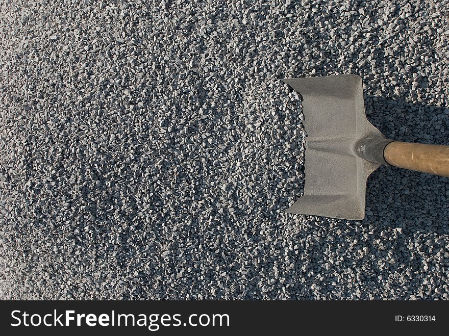 A Shovel stick out of the pile of gravel. A Shovel stick out of the pile of gravel.