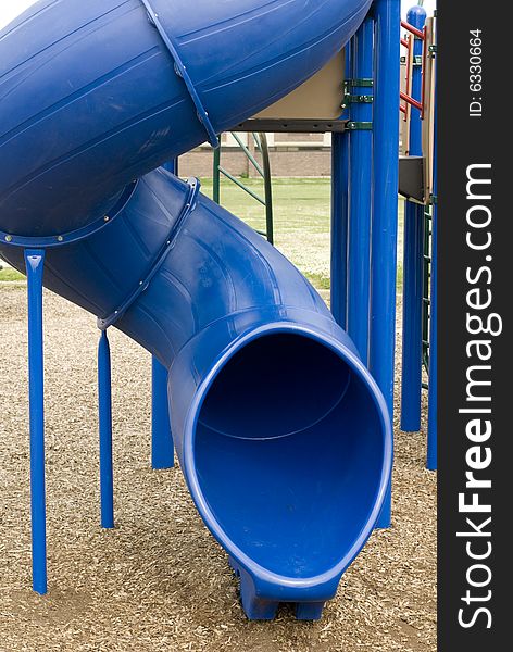 Frontal view of a playground's blue plastic slide. Frontal view of a playground's blue plastic slide