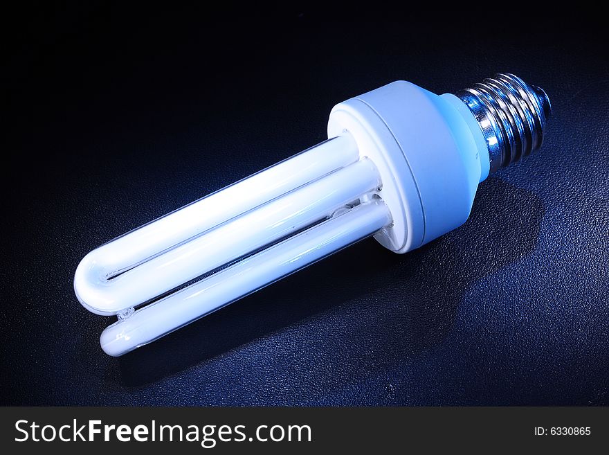 Background with white energy-efficient electric bulb. Background with white energy-efficient electric bulb