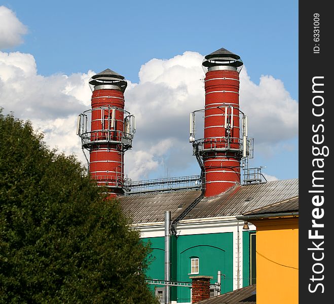 Two big red chimney of brewery in summer. Two big red chimney of brewery in summer