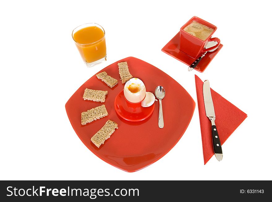 Breakfast arrangement with egg, coffee and orange juice isolated on white background