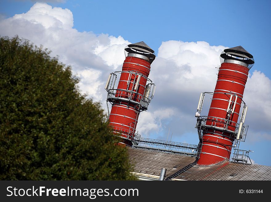 Two big red chimney of brewery in summer. Two big red chimney of brewery in summer