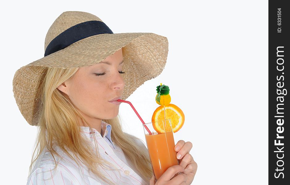 Young woman enjoying a long drink with straw.Wearing a straw hat. Young woman enjoying a long drink with straw.Wearing a straw hat.