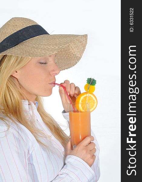 Young woman enjoying a long drink with straw.Wearing a straw hat. Young woman enjoying a long drink with straw.Wearing a straw hat.