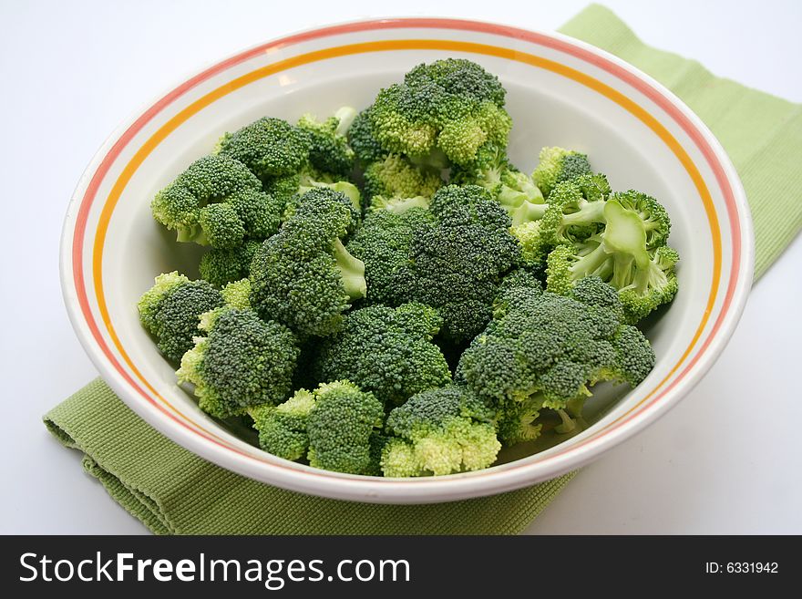 Some fresh, uncooked broccoli in a bowl