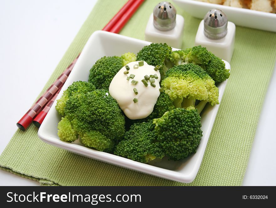 A meal of fresh broccoli with some cream